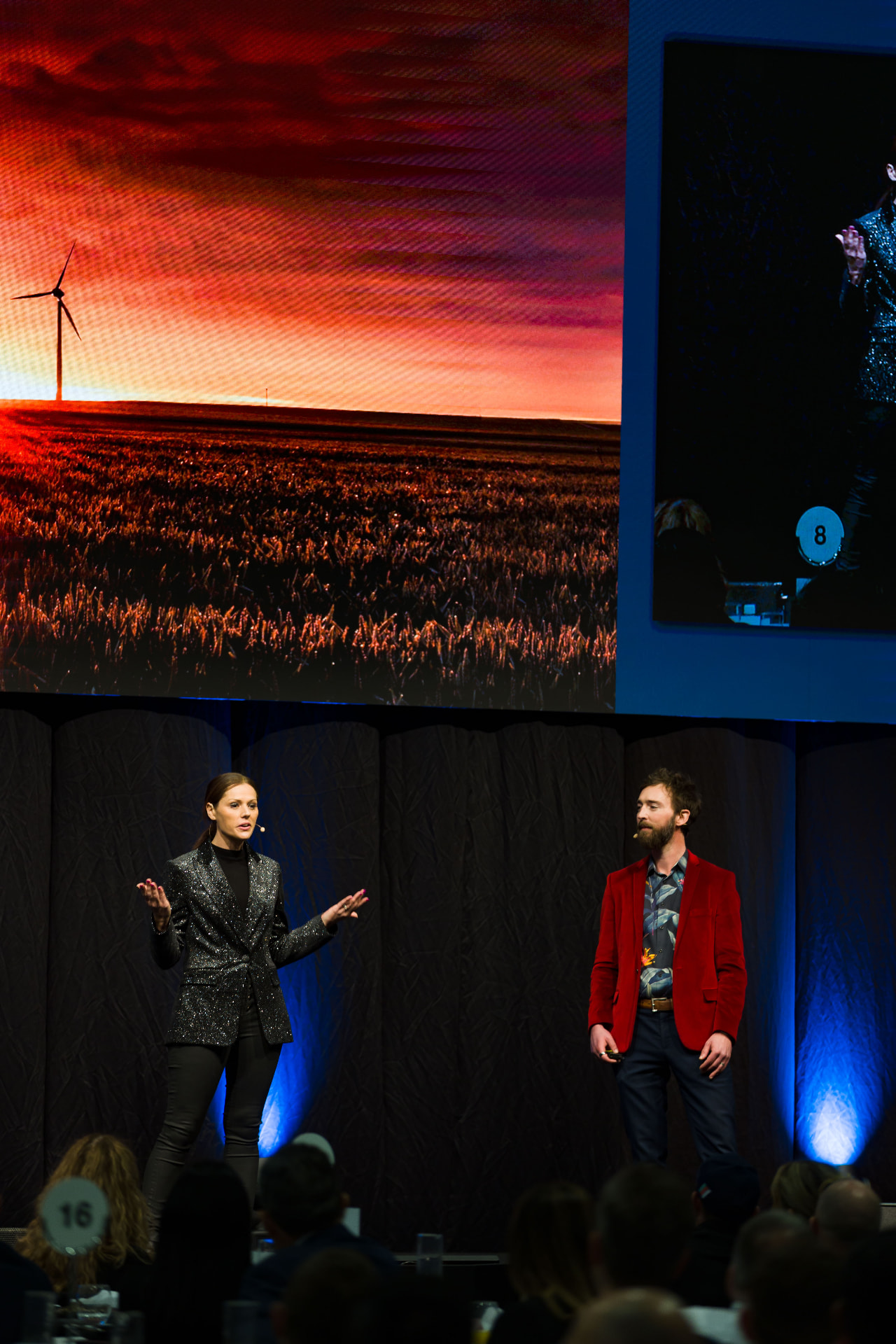 Rebecca Maklad speaking on stage with a co-presenter during a Humanity Schools presentation